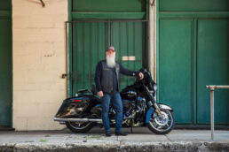 Environmental portrait on location in Tampa, Florida of older man with long white beard and Harley Davidson in the Ybor City area.