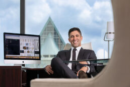 Professional, business portrait of attorney in his office overlooking Tampa, Florida.