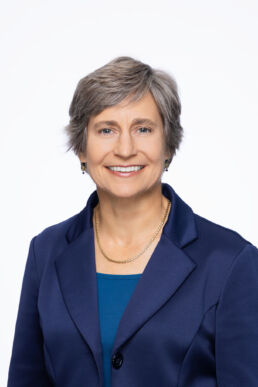 Professional headshot of female executive in studio setting against a white background on location in Tampa, Florida.