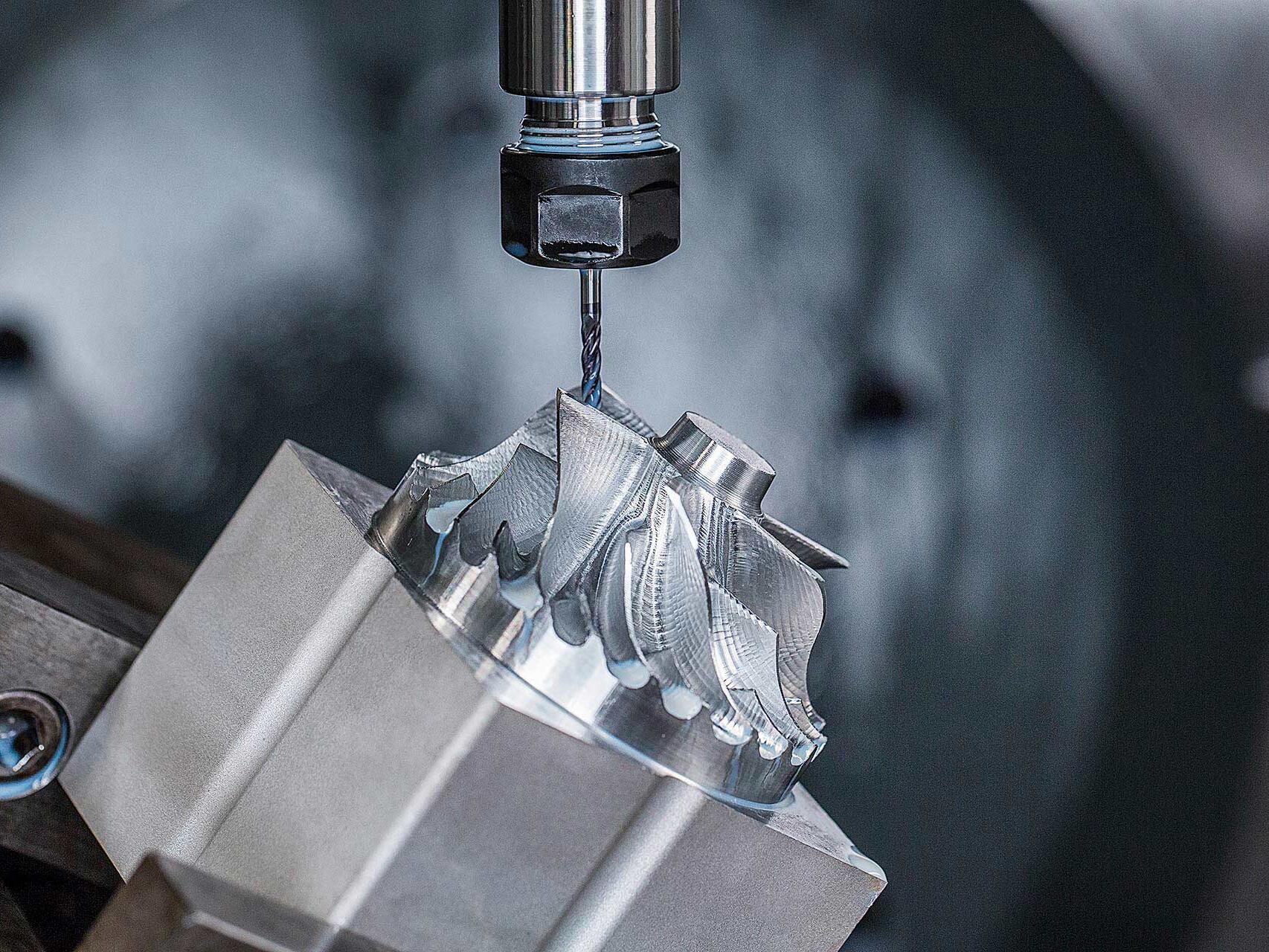Commercial industrial photography on location of CNC machine milling metal gear at Seaway Plastics in Port Richey, Florida.