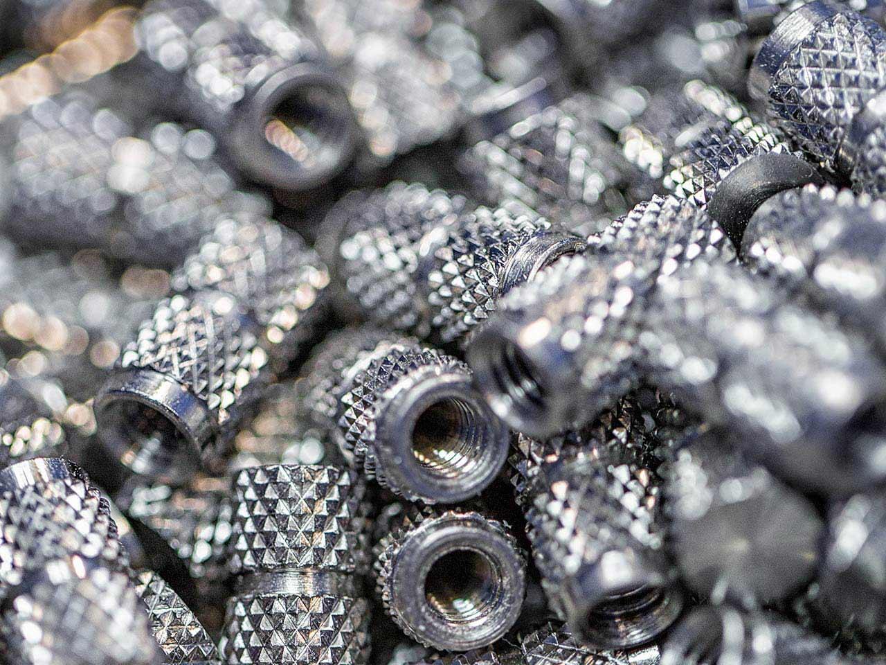 Detail photo of small metal parts manufactured by cnc machines at Seaway Plastics in Port Richey, Florida - commercial industrial photography by Tampa based Carver Mostardi Photography.