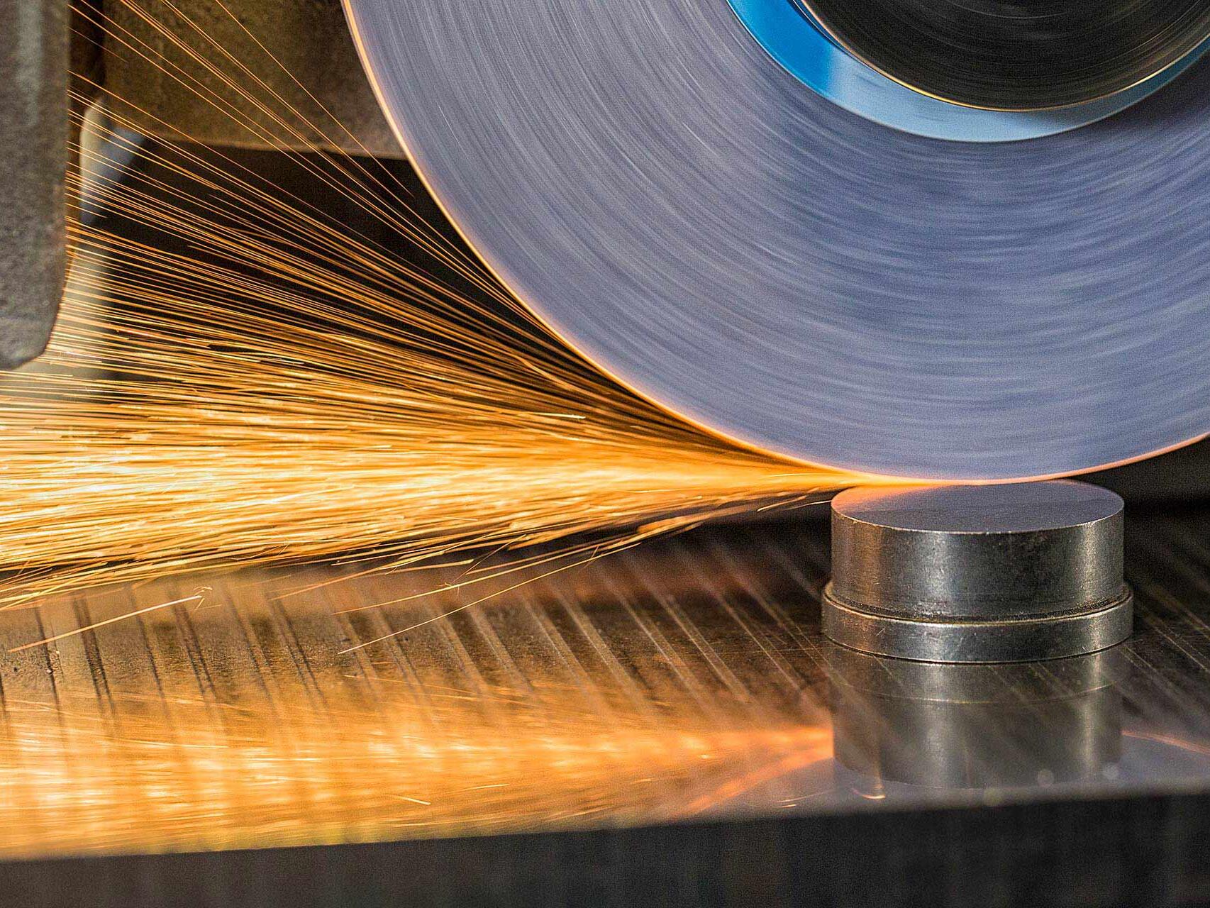 Sparks fly from a commercial sanding machine photographed by Tampa commercial photographer Carver Mostardi.