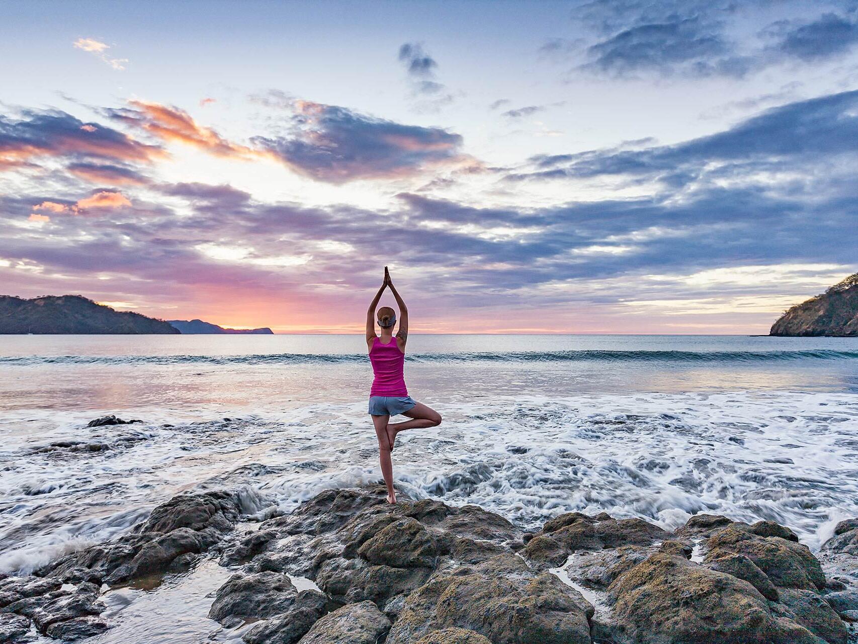 Woman doing sunset yoga in Playa del Coco, Costa Rica by Tampa commercial photographer Carver Mostardi.