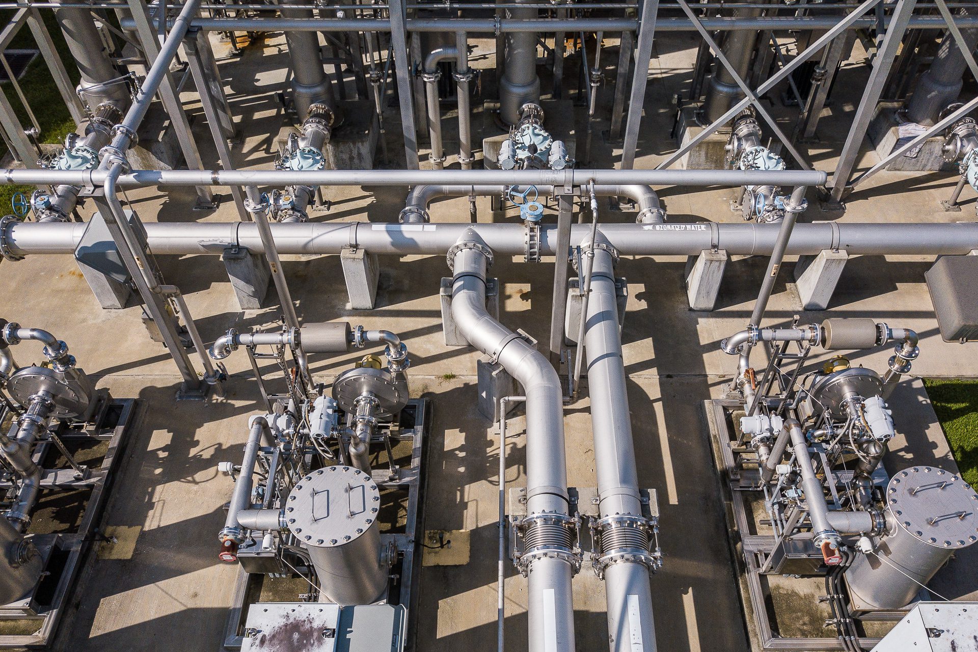 Detailed image of industrial piping and mechanical systems within a power or water facility.