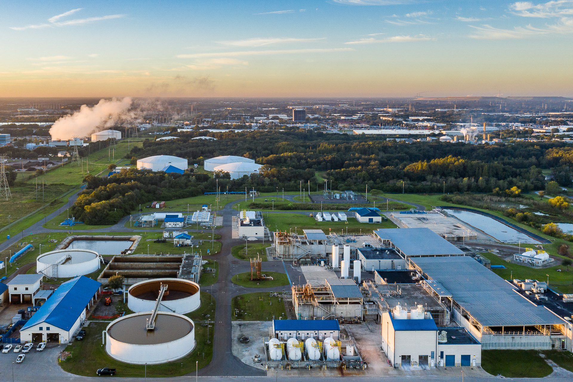 Aerial industrial photo of water-treatment or energy plant at sunrise.