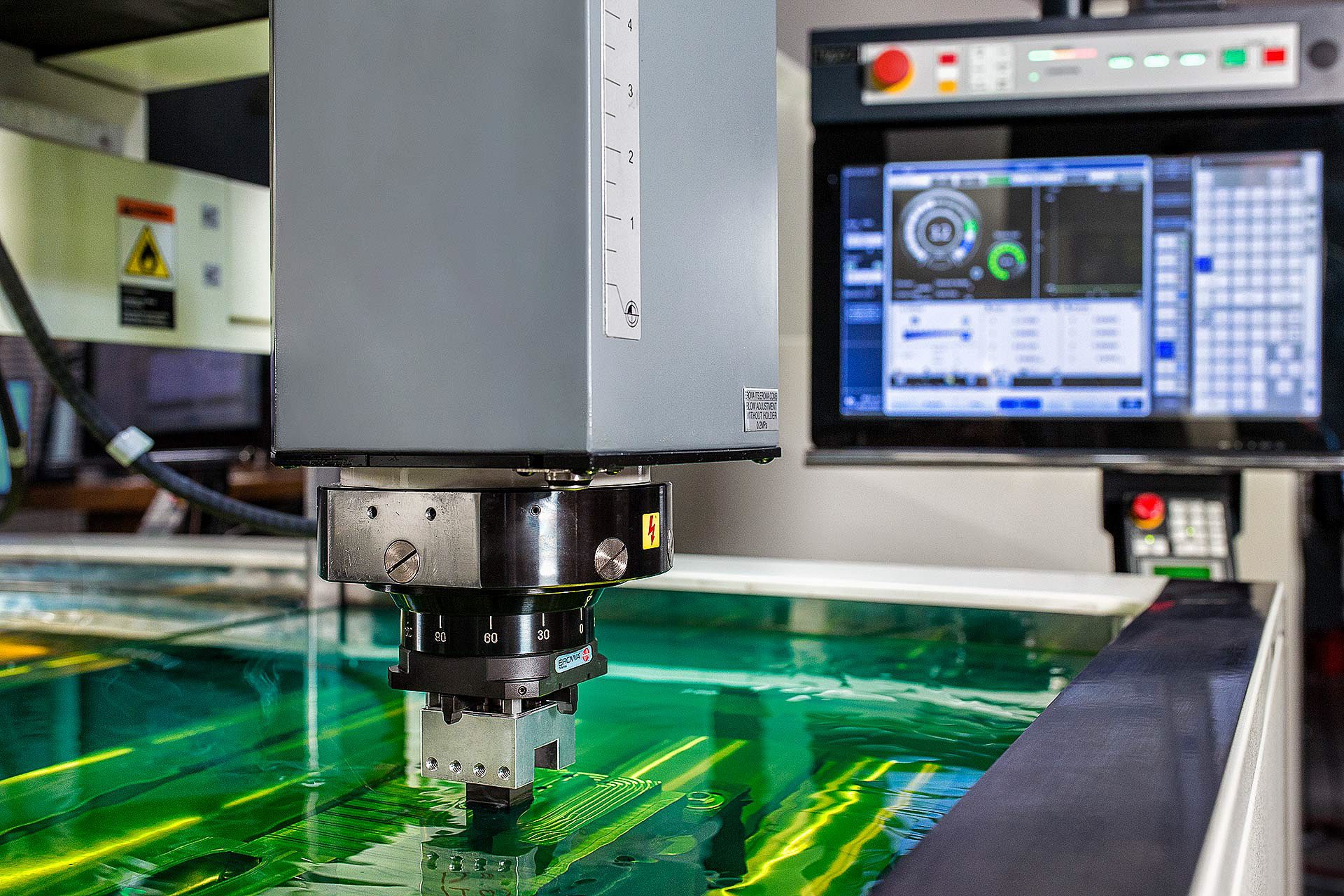 Close-up photo of EDM machining process used for aerospace components.