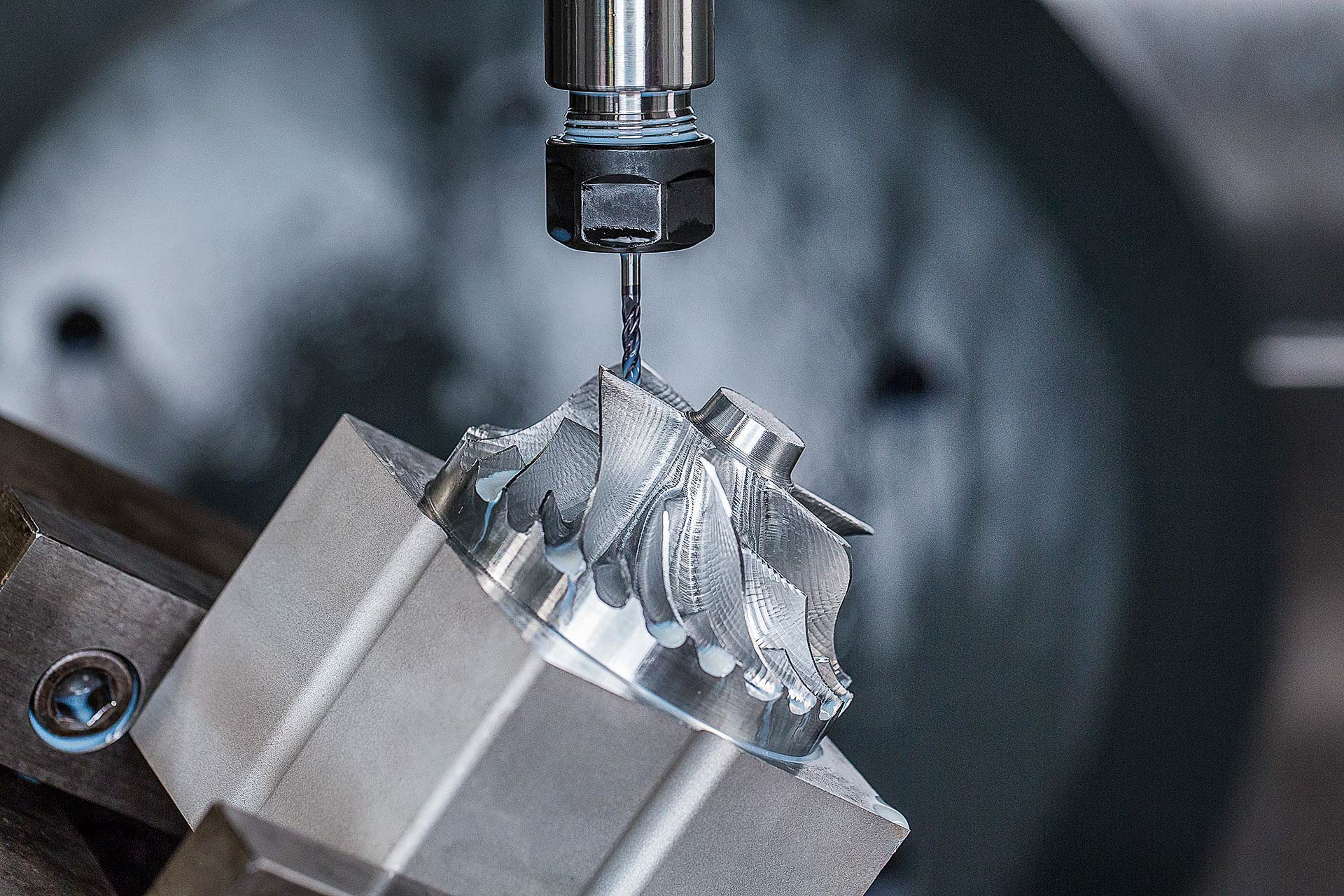 Macro industrial image of CNC machining of aerospace and manufacturing components.