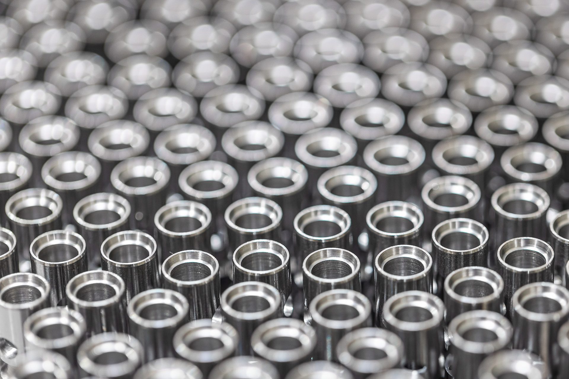 Industrial photography of precision metal components for aerospace manufacturing.