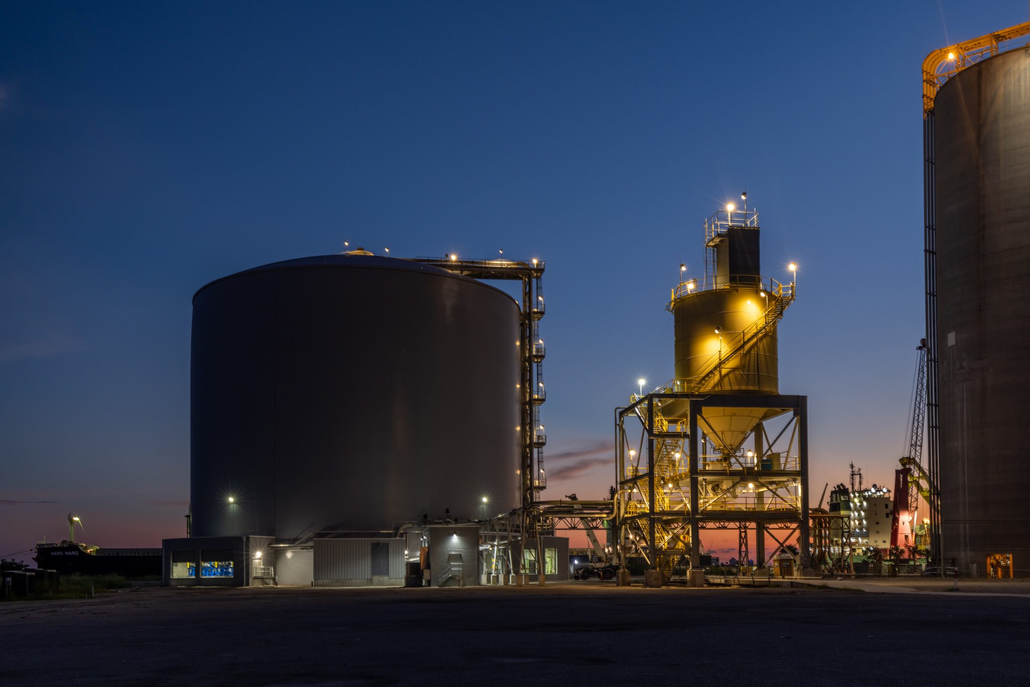 Aerial view of an illuminated industrial facility at night near Orlando, Florida.