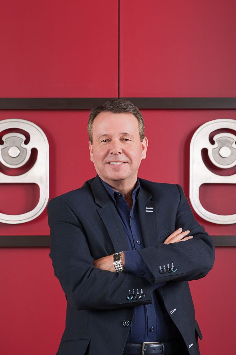 Tampa corporate photographer capturing CEO leadership portrait in modern office with red metallic accents.