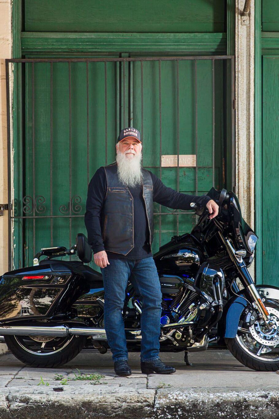 Tampa corporate photographer creating environmental business portrait of professional man beside motorcycle in urban setting.