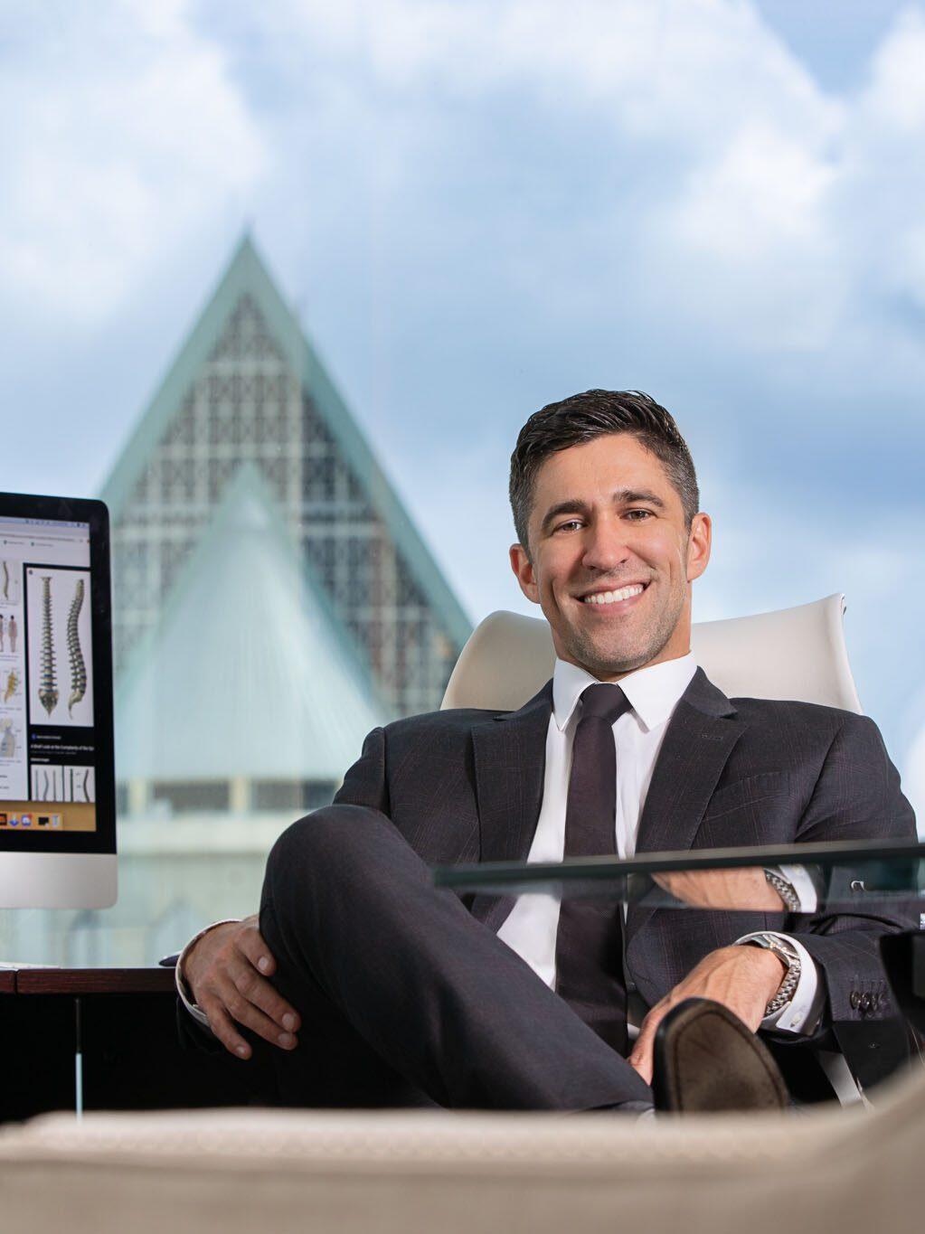 Executive headshot photographed in Tampa studio by corporate photographer using soft blue background.