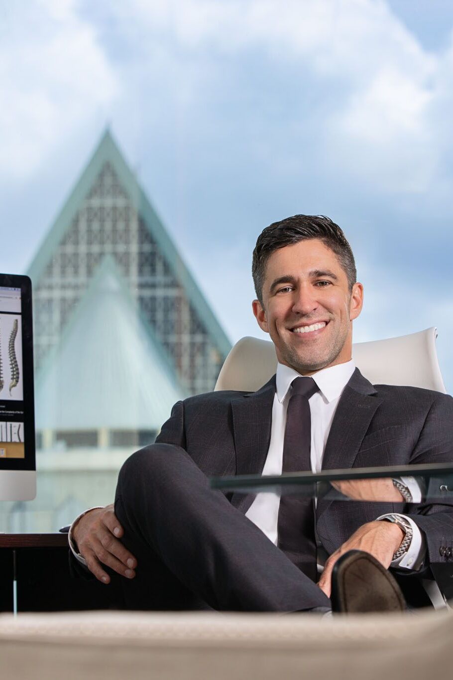 Executive headshot photographed in Tampa studio by corporate photographer using soft blue background.