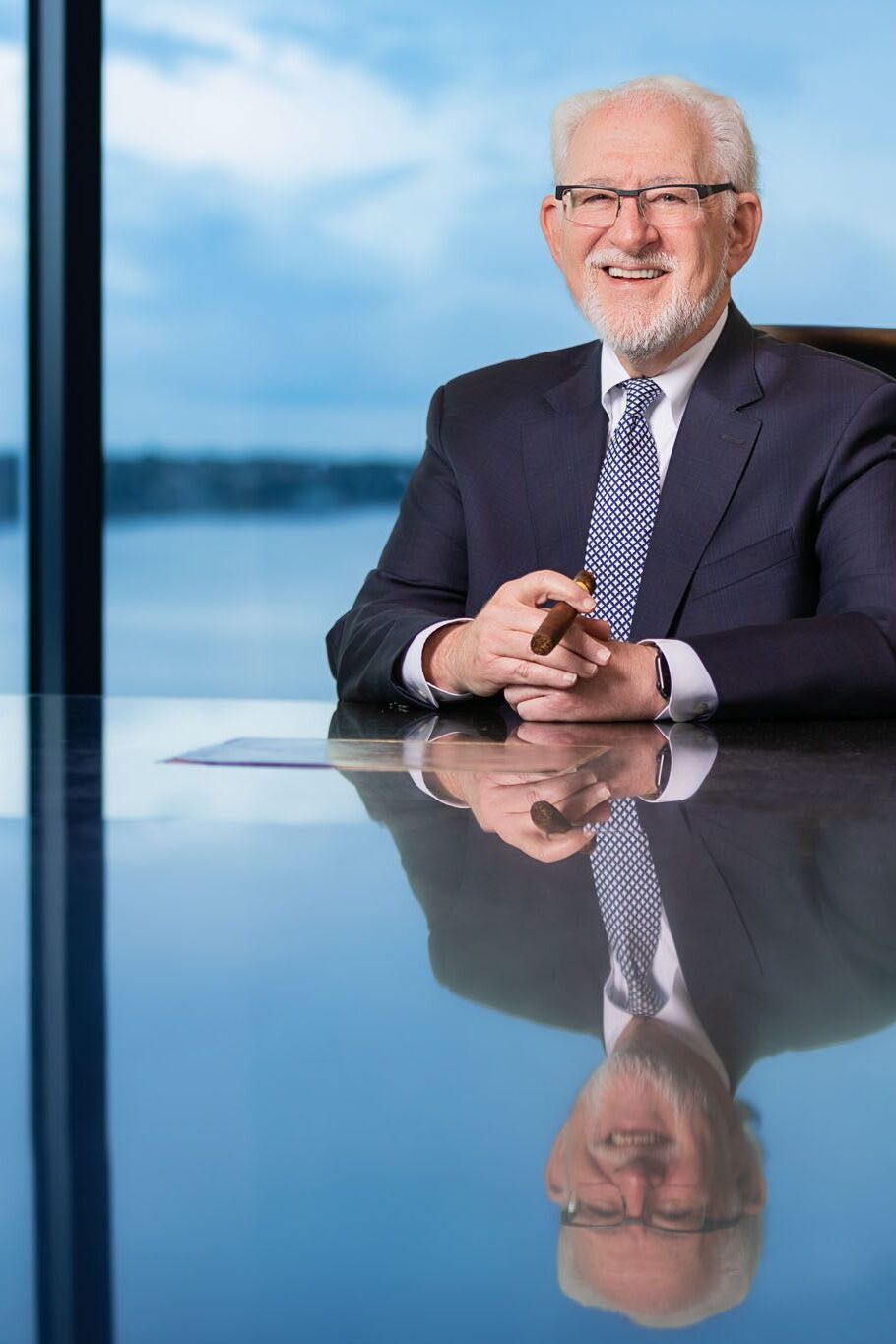 Corporate photographer in Tampa creating executive portrait on-location in office with bay view windows.