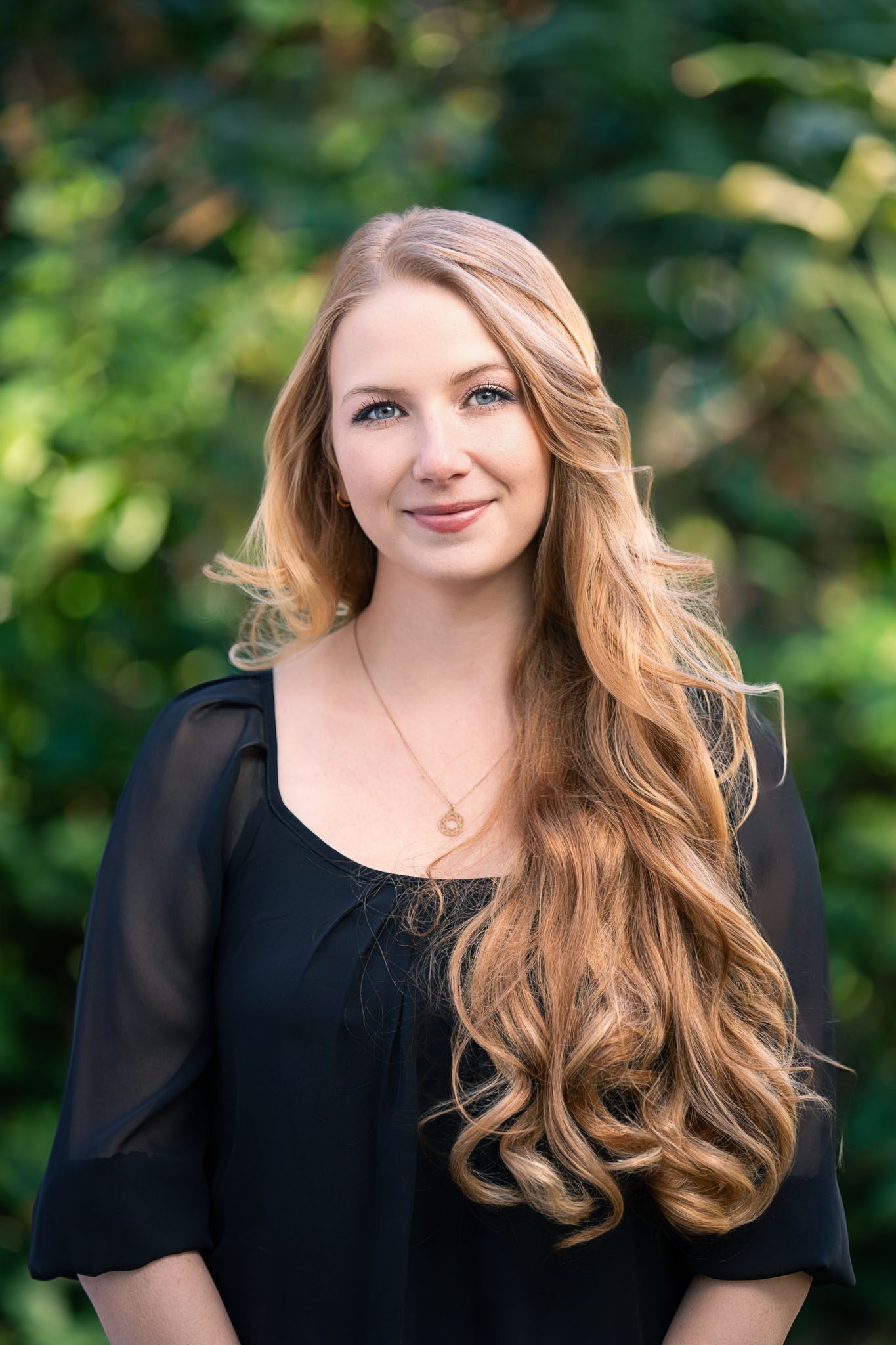Tampa corporate photographer capturing outdoor professional headshot with natural light and soft blurred background.