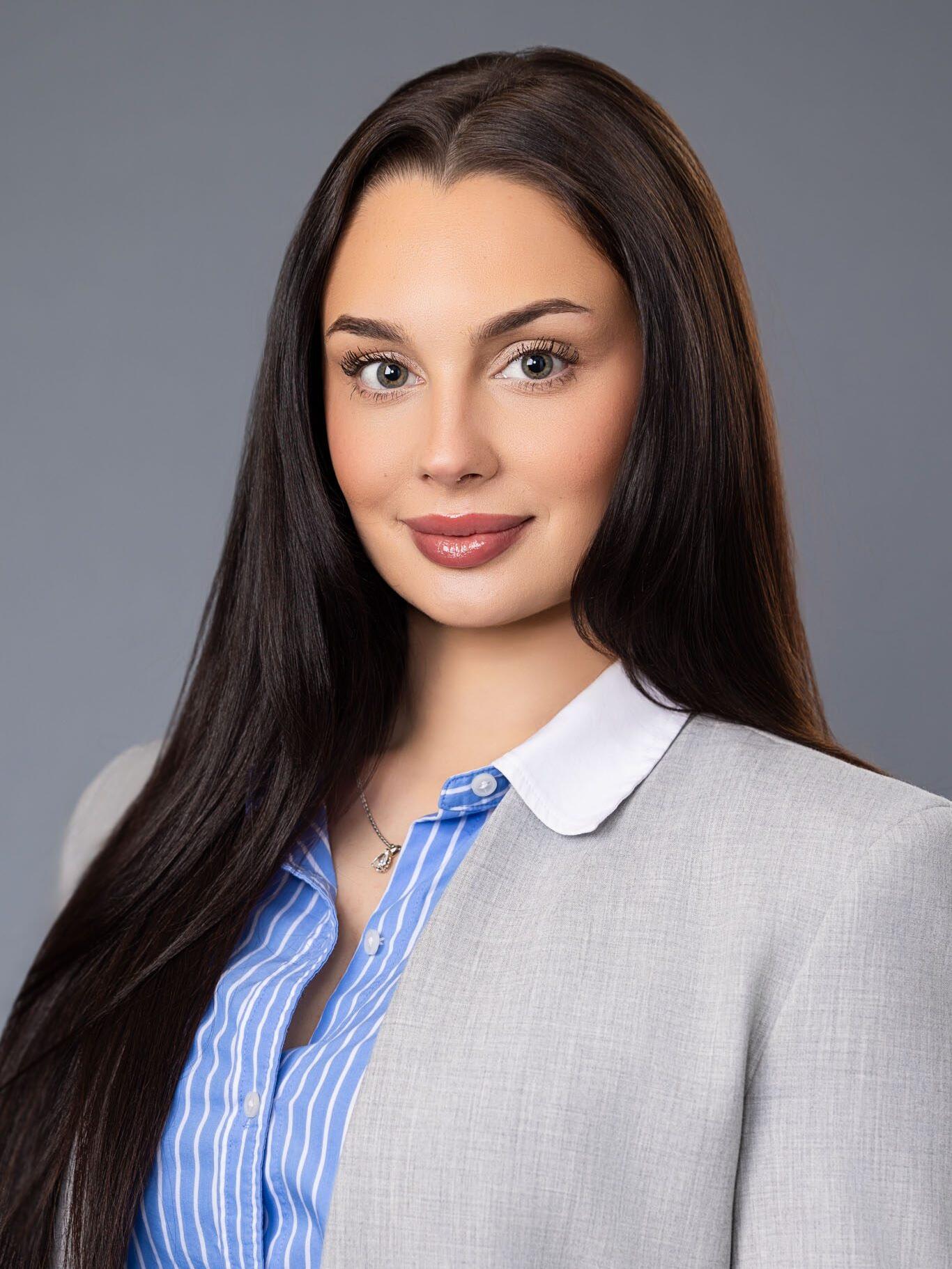 Professional Tampa corporate photographer creating studio business headshot on gray background.