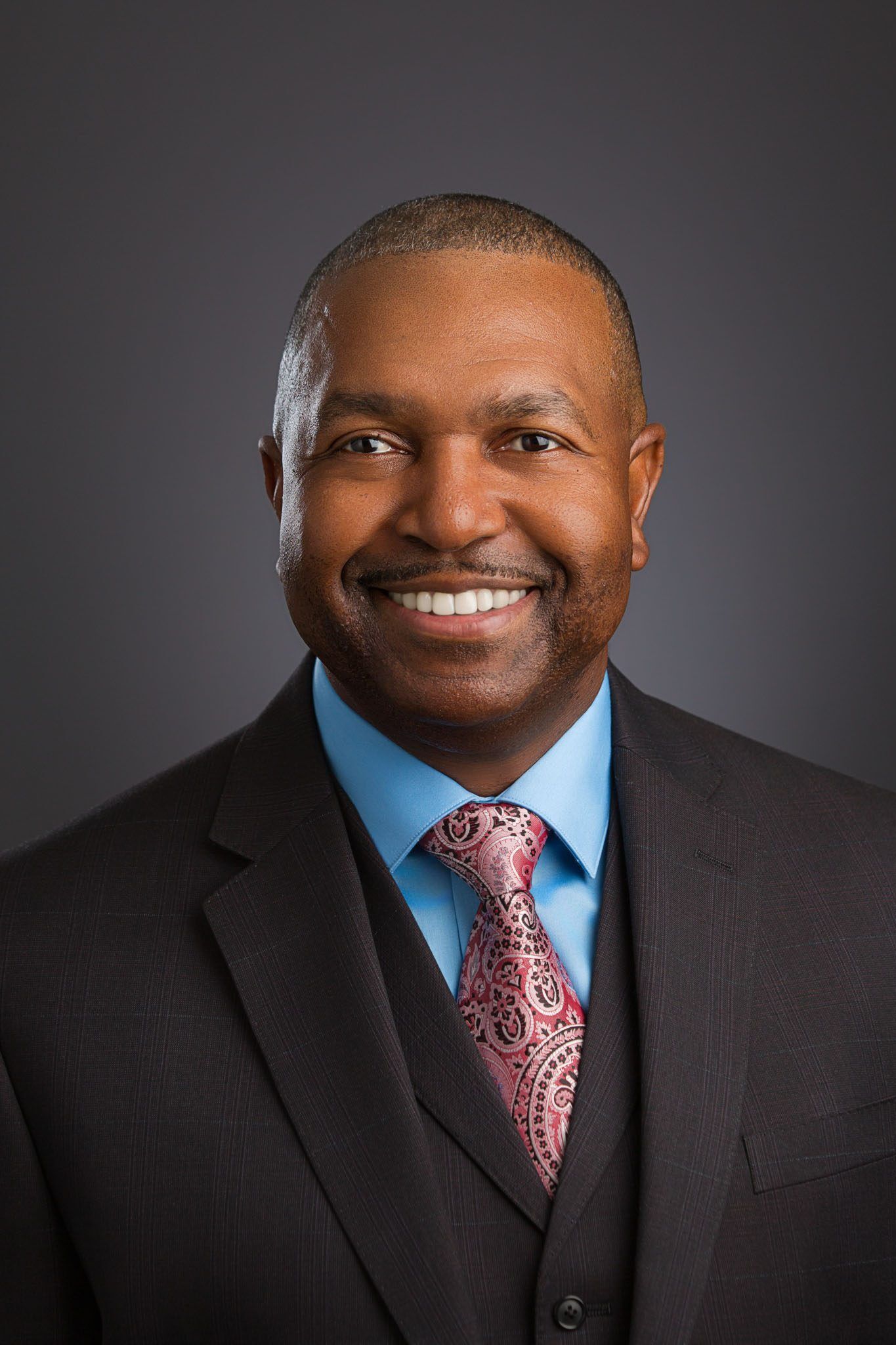 Tampa corporate photographer lighting professional studio headshot with soft gray background for business branding.