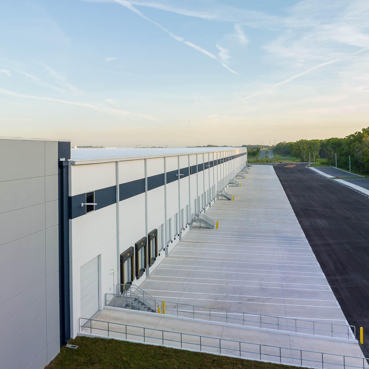 Aerial drone photograph of a modern fulfillment center with empty loading docks and paved truck lanes near Tampa, Florida.