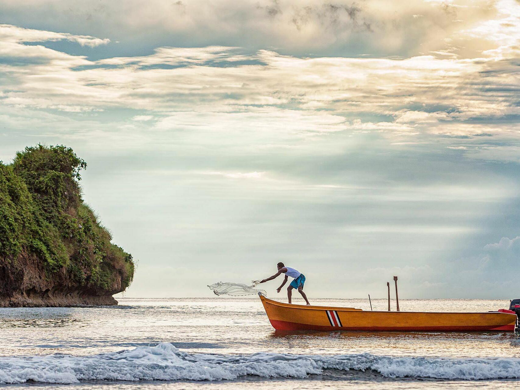 Fisherman casting net at sunrise - lifestyle environmental photography Tampa Bay.