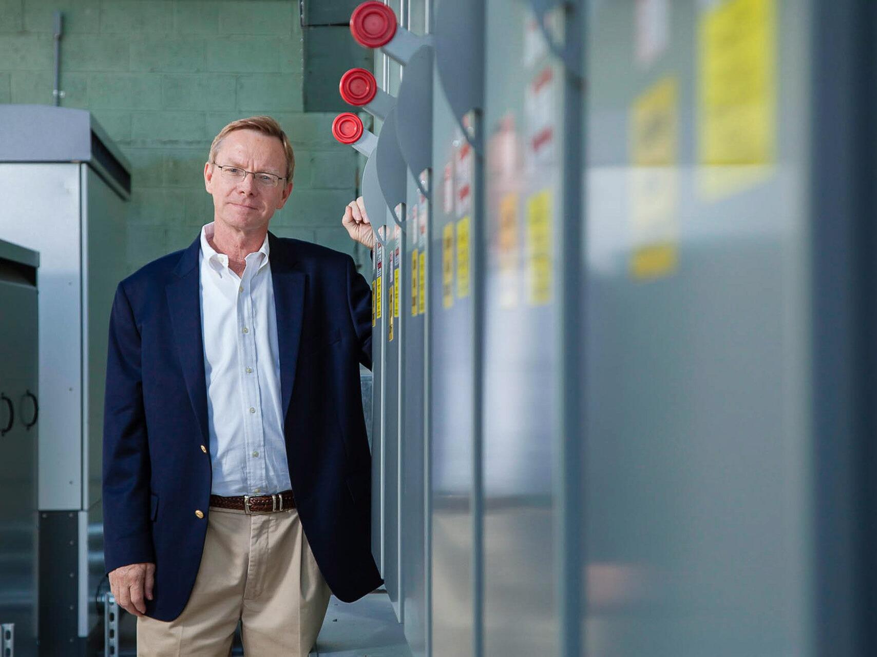 Executive with solar transformers - corporate environmental portrait by Tampa commercial photographer.