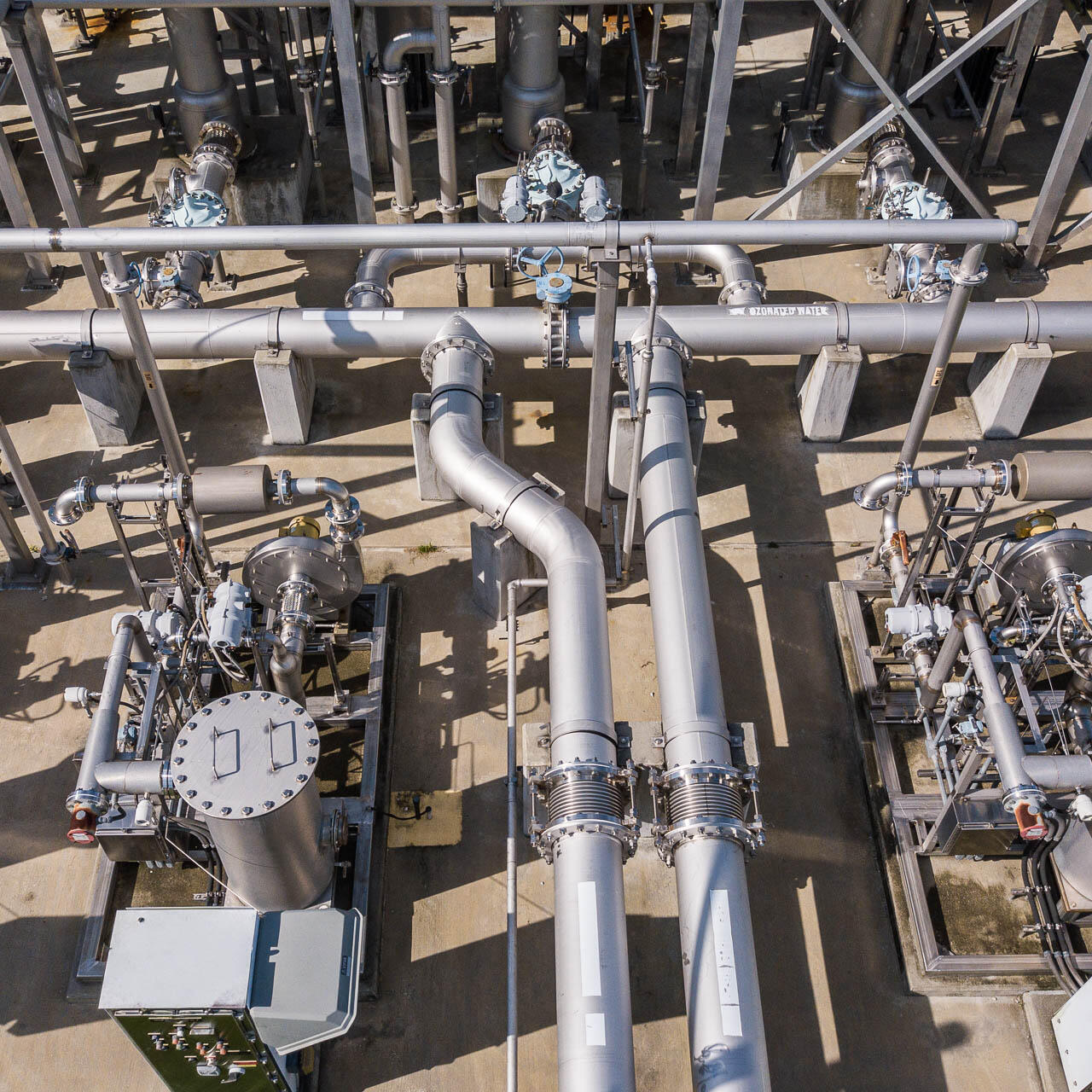 Aerial drone photograph of industrial water treatment facility with stainless steel pipelines in Tampa, Florida.