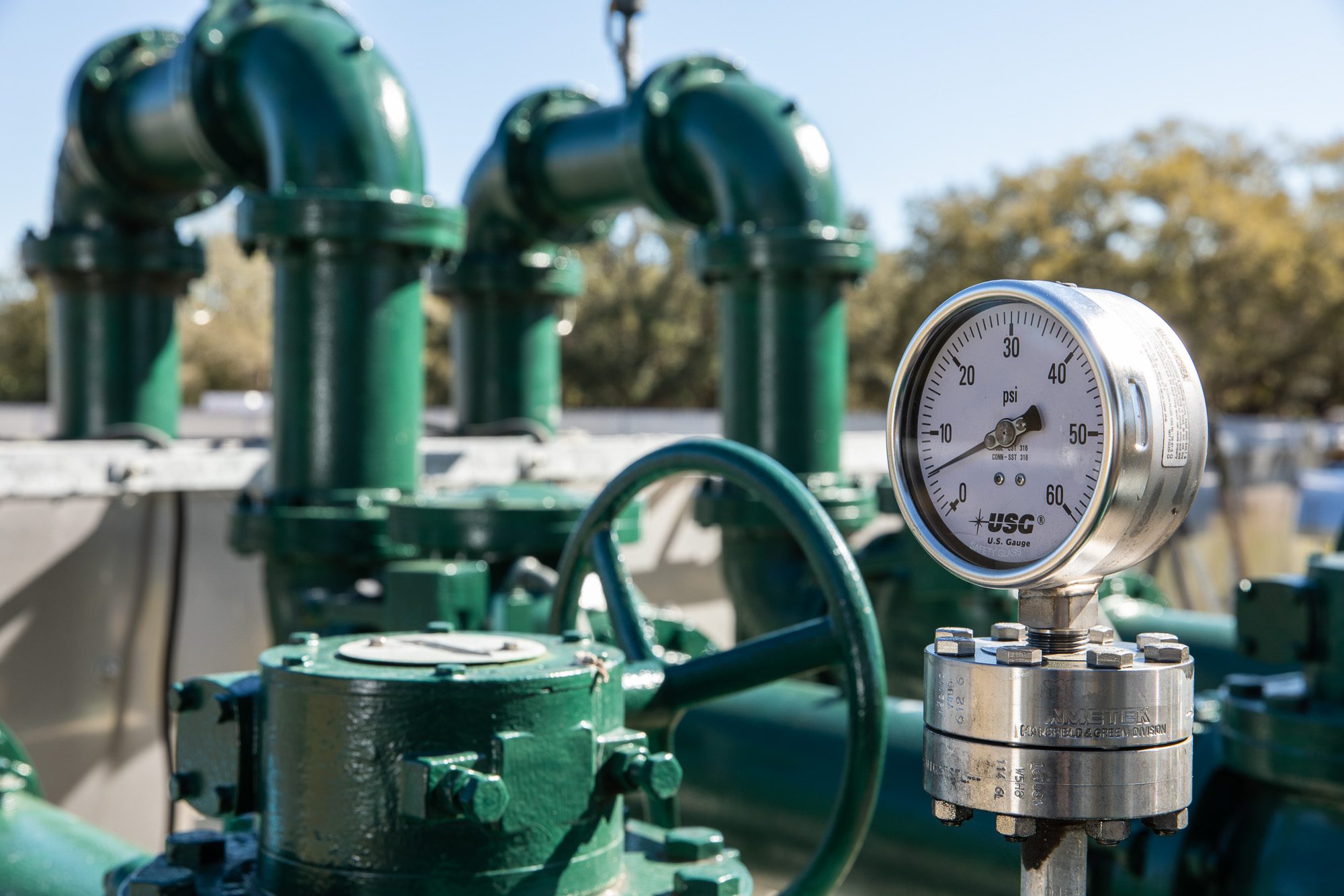 Close-up of pressure gauge and valve assembly on water system pipeline - industrial detail photography